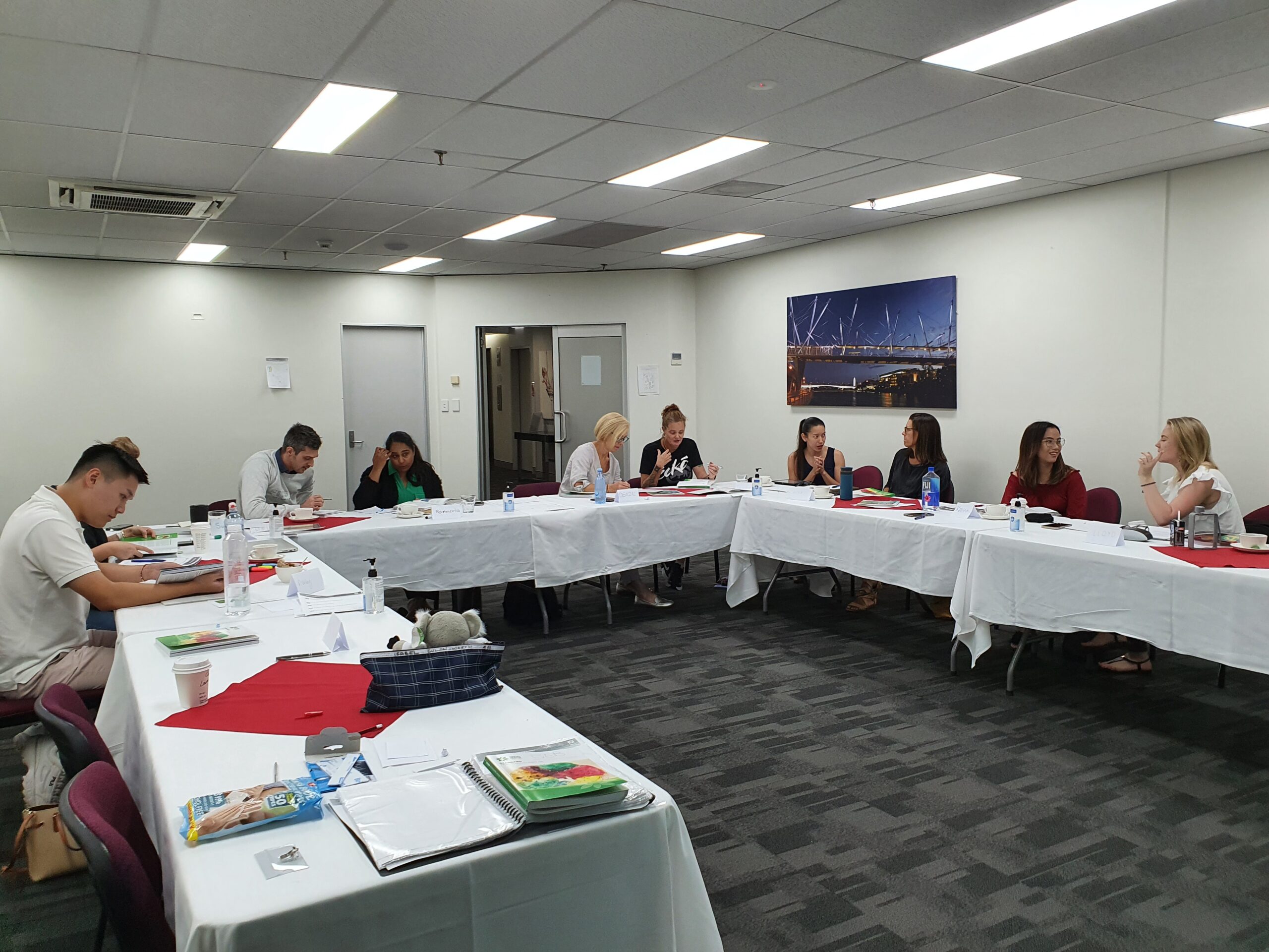 Instructor leading a mental health first aid training session with employees in a modern office setting